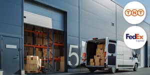 Courier truck parked outside warehouse with TNT lo