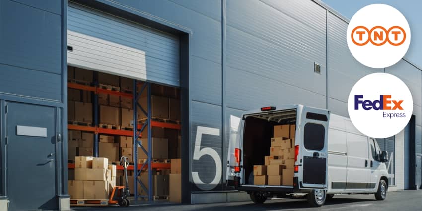 Courier truck parked outside warehouse with TNT lo